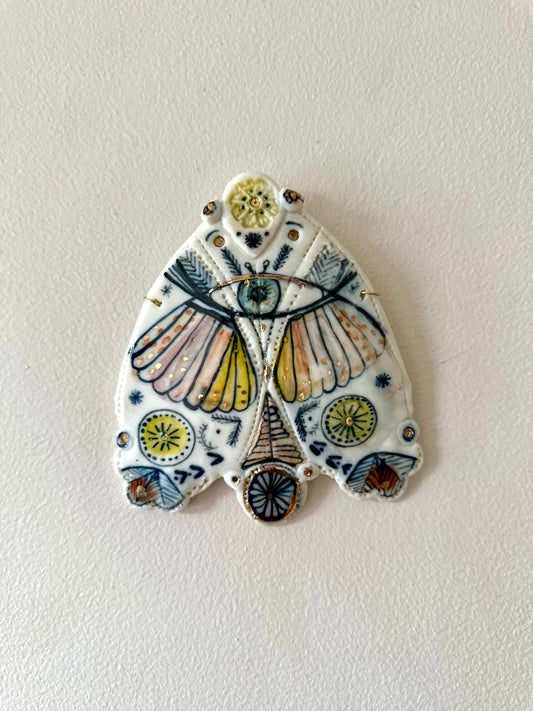 ‘Protecti e eye moth’ porcelain wall piece, small gold lustre detail
